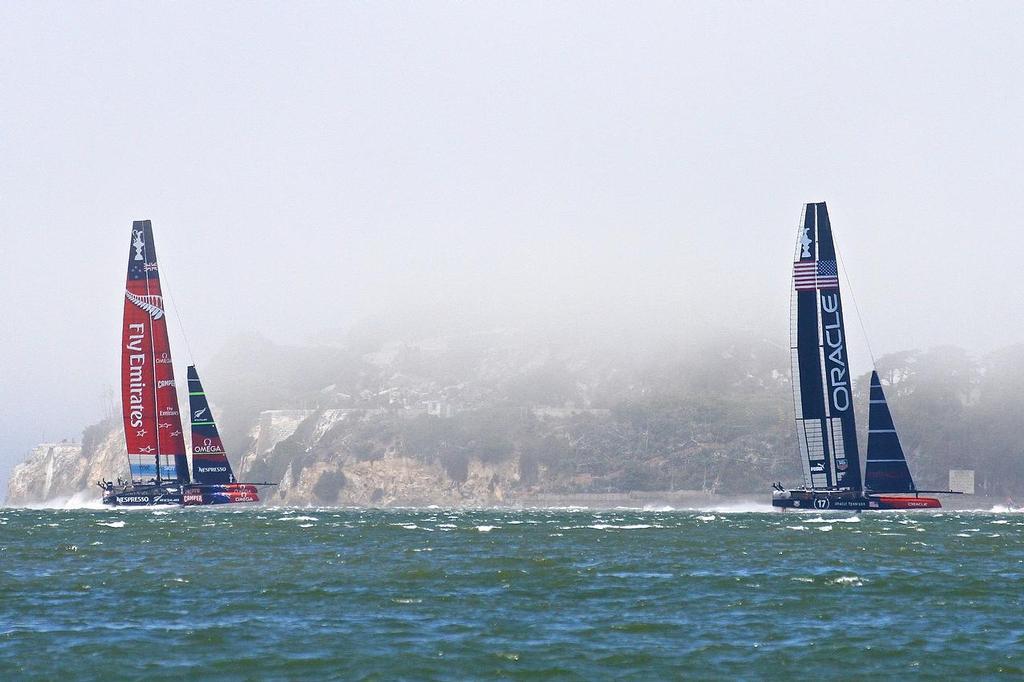 Oracle Team USA v Emirates Team New Zealand. America’s Cup Day 2, San Francisco. Emirates Team NZ chases Oracle Team USA down the back straight of Leg 4, Race 4 with Alcatraz in the background © Richard Gladwell www.photosport.co.nz